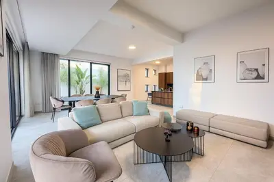 a living room with a couch and a table at Sunrise Pearl - 2 min walk to Sirena Bay in Paralimni