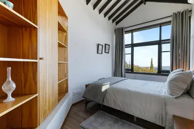 a bedroom with a bed and a large window at Horizon View Lefkara with Pool, Garden, Parking in Pano Lefkara