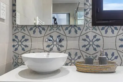 a bathroom with a white sink and a mirror at Horizon View Lefkara with Pool, Garden, Parking in Pano Lefkara