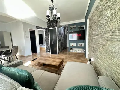 a living room with a couch and a table at Serenity Home - Holiday Apt Larnaca in Larnaka