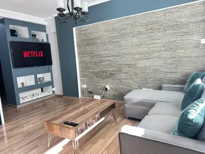 a living room with a couch and a coffee table at Serenity Home - Holiday Apt Larnaca in Larnaka