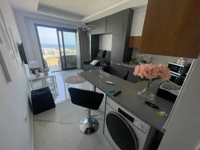 a kitchen with a counter with a vase of flowers on it at Studıo Iskele 150 in Aglantzia