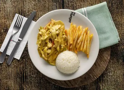 a plate of food with rice and french fries at Studıo Iskele 150 in Aglantzia