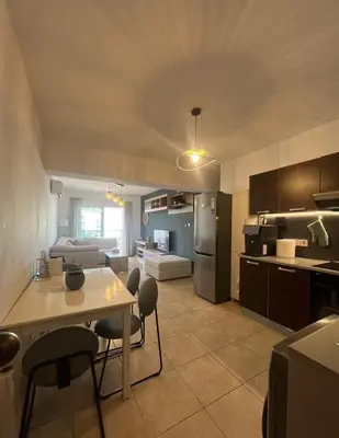 a kitchen and living room with a table and chairs at 2 bedroom flat in centre in Larnaka