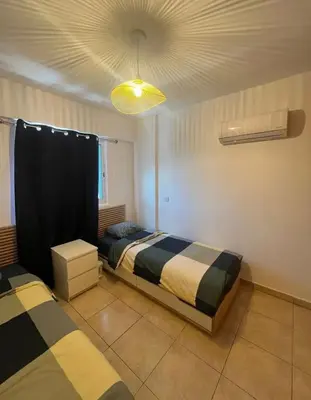 a bedroom with two beds and a ceiling at 2 bedroom flat in centre in Larnaka