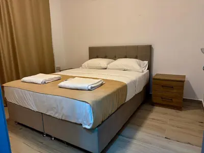 a bedroom with a large bed with two pillows on it at Soğular Apartments 1 in Aglantzia