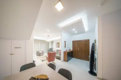 a room with a dining table and a living room at Villa Oro Hills w private hot tub jacuzzi in Voroklini
