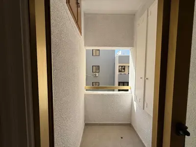 an empty hallway with a view of a kitchen at One-bedroom apartment next to Radisson Blu in Larnaka