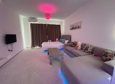 a living room with a couch and a table at Hotel apartment studio in Dherinia
