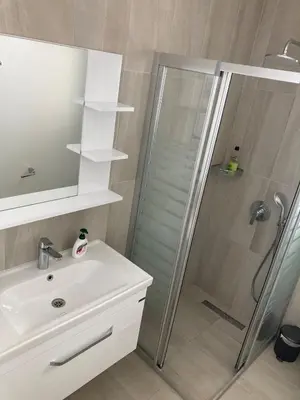 a bathroom with a shower and a sink at Hotel apartment studio in Dherinia