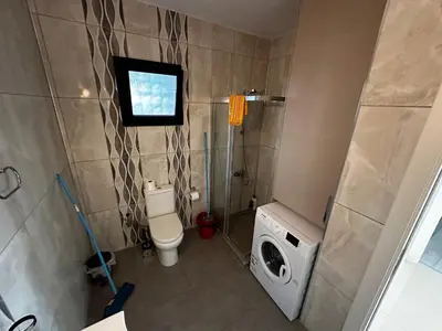 a bathroom with a toilet and a washing machine at Avrasya site, Luxury one-bedroom apartment in Kyrenia city center