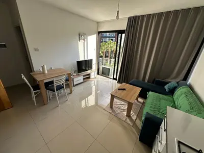 a living room with a couch and a table at Avrasya site, Luxury one-bedroom apartment in Kyrenia city center