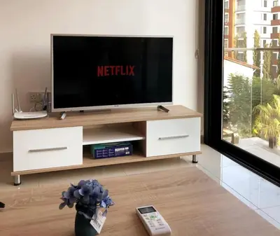 a living room with a television on a entertainment center at Avrasya site, Luxury one-bedroom apartment in Kyrenia city center