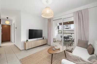 a living room with a couch and a tv at Downtown Stadium 3 Bedroom Apartment in Larnaka