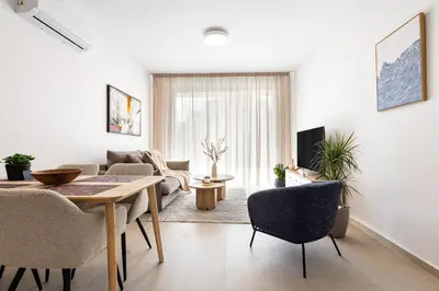 a living room with a table and chairs at Chrystal Residences in Nicosia