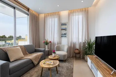 a living room with a couch and a tv at Chrystal Residences in Nicosia