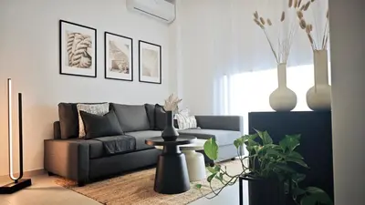 a living room with a couch and vases on the wall at City and Sea 12 in Larnaka