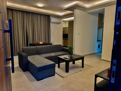 a living room with a couch and a table at Soğular Apartments 1 in Aglantzia
