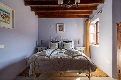 a bedroom with a bed with a wooden ceiling at Villa Monti Cozy Yard & BBQ Perfect for Families & Friends in Kato Lefkara