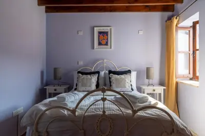 a bedroom with a large bed with blue walls at Villa Monti Cozy Yard & BBQ Perfect for Families & Friends in Kato Lefkara