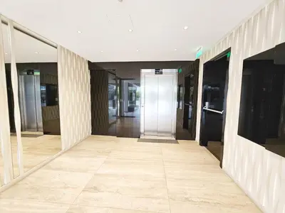 an empty hallway of an office building with glass doors at Alexander Residence Trikallon Str in Nicosia