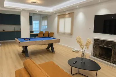 a living room with a pool table and a fireplace at GameHouse in the City Center in Nicosia