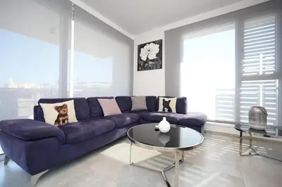 a living room with a purple couch and a table at Larnaca Salt Lake Gem, Airy 2 BDRM Apartment in Larnaka