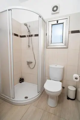 a bathroom with a shower and a toilet at Stunning Mackenzie Sea Views Beach Flat,1 Bedroom in Larnaka