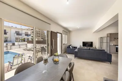 a living room with a table and a couch at SunnyVillas 3BR House Private Pool POLY in Protaras