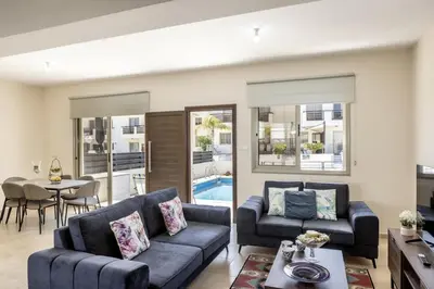 a living room with a couch and a table at SunnyVillas 3BR House Private Pool POLY in Protaras