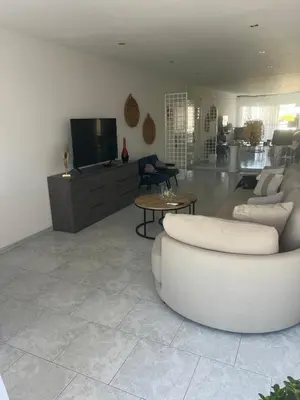 a living room with a white couch and a tv at City Center Getaway in Nicosia