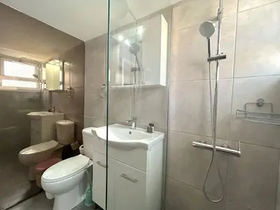 a bathroom with a shower and a toilet and a sink at City Center Getaway in Nicosia