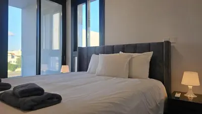 a bedroom with a large bed with a large window at STAY Engomi Gem 2 in Engomi