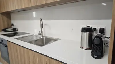 a kitchen counter with a sink and a coffee maker at STAY Engomi Gem 2 in Engomi
