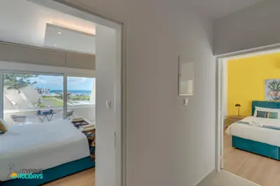 a bedroom with two beds and a view of the ocean at Lordos Deluxe 2bd Duplex with pool and Seaview in Larnaka