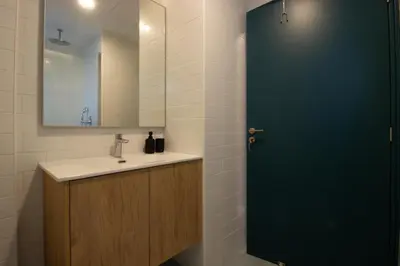 a bathroom with a sink and a green door at M-Studios - Luxury studios in the heart of Limassol in Limassol