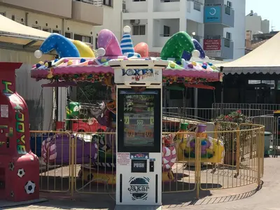 a ticket machine in front of a carnival ride at Panoramic Sea View Apartments in Larnaka