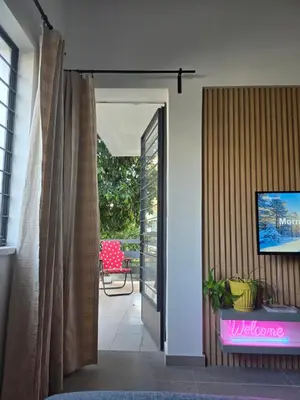 a living room with a television on a wall at Flat Koskluciftlik in Nicosia