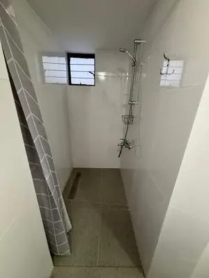 a white bathroom with a shower and a window at Flat Koskluciftlik in Nicosia