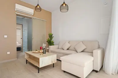 a living room with a couch and a coffee table at SunnyVillas Suite Mythical GYM Swimming Pool S19 in Paralimni