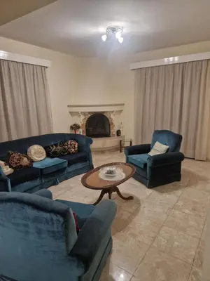 a living room with two blue couches and a table at Urban Nest Central Nicosia - Spacious 2BR Apartment in Nicosia