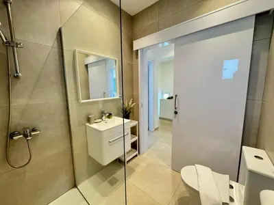 a bathroom with a toilet and a sink and a shower at Seaside Sunrise Familly Villa in Paralimni