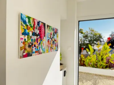 a painting hanging on a wall next to a window at Seaside Sunrise Familly Villa in Paralimni
