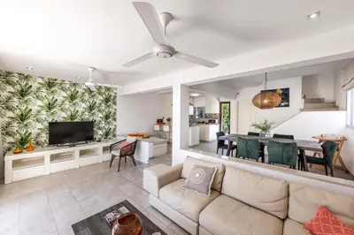 a living room with a couch and a dining room at Pantaros Luxury Villas with pool in Paralimni