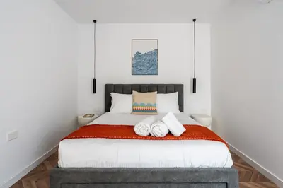a bedroom with a bed with two towels on it at Modern Luxury 2BR|Park View & Balcony in Nicosia