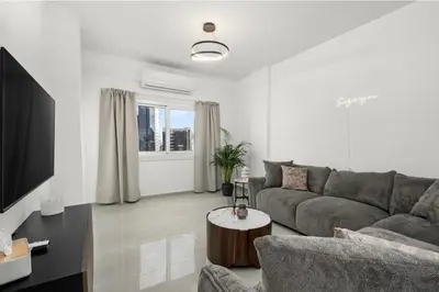 a living room with a couch and a table at Mnasiadou Suite 16 in Nicosia