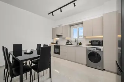 a kitchen and dining room with a table and chairs at Mnasiadou Suite 16 in Nicosia
