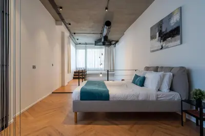 a bedroom with a large bed in a room at Cozy Loft with Balcony in Central Limassol in Limassol