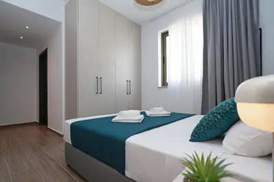 a bedroom with a large bed with blue sheets and pillows at Villa Elsa - Luxury Villa in Pernera in Paralimni