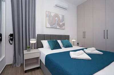 a bedroom with a blue and white bed with towels on it at Villa Esmeralda - Luxury Villa in Pernera in Paralimni